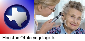 Houston, Texas - a otolaryngologist examining the ear of a patient