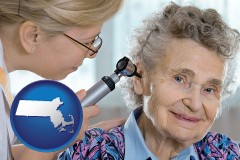 ma map icon and a otolaryngologist examining the ear of a patient