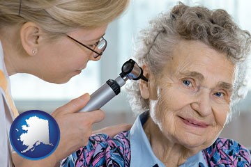 a otolaryngologist examining the ear of a patient - with Alaska icon
