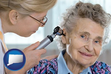 a otolaryngologist examining the ear of a patient - with Connecticut icon